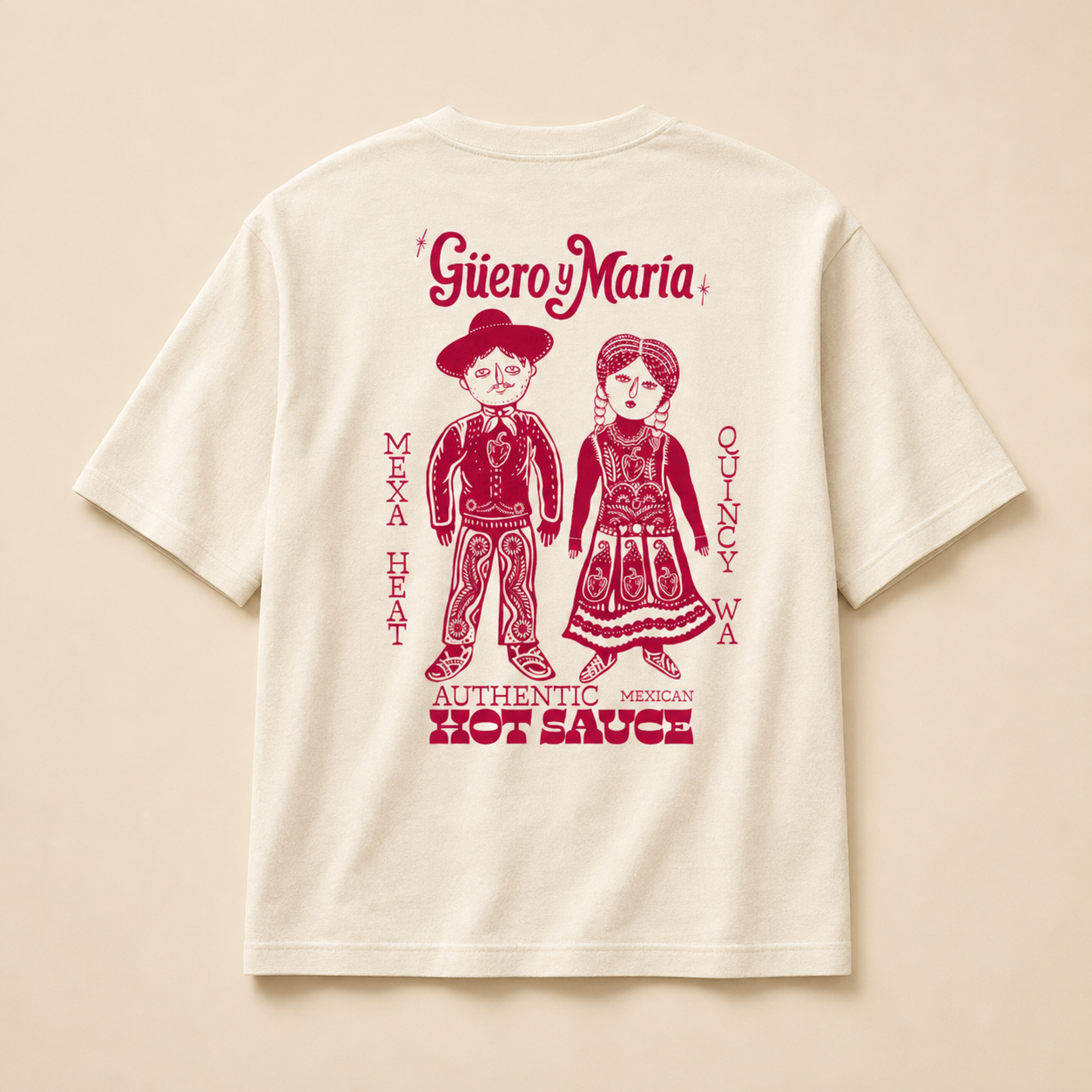 An off-white short-sleeve t-shirt shown from the back, featuring a red graphic print of a man and a woman in traditional Mexican attire with the text 'Guero Maria' and 'Authentic Mexican Hot Sauce'.